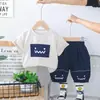 Comercio Exterior Ropa Infantil al por Mayor 2025 Nuevo Verano Lindo Cuadrado Cara Sonriente Traje de Manga Corta Camiseta Pantalones Cortos Traje