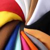 En stock suministro tejido poliéster felpa de un solo lado forro polar suéter ropa interior tela de felpa de un solo lado con cerdas