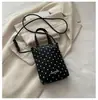Mini bolso para teléfono móvil con colgante de corazón de lunares de color sólido estilo coreano transfronterizo, bolso de mano de cuero suave, bolso cruzado para niñas