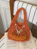 Bolso de Punto Calado de Diseño de Nicho para Mujer 2026 Nuevo Verano Estilo Coreano Versátil Bolso Tejido Hecho a Mano Bolso de Cubo de Mano