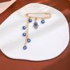 Broche de borla de ojo de diablo con incrustaciones de diamantes, estilo creativo europeo y americano, con sentido avanzado, ojos azules, suéter de cintura ajustada, broche de viento frío