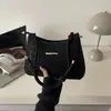 Bolsas de Alto Valor Estético para Mujer Primavera 2026 Nuevo Bolso de Hombro para Viaje Diario Moda Simple Diseño de Nicho Bolso Tote Pequeño de Hombro Único