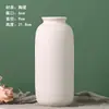 Una generación de jarrón de cerámica para quemar pigmento blanco al por mayor para plantar agua, adornos de flores secas, puesto de suministro, outlet de fábrica