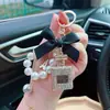 Colgante Creativo para Bolso de Cadena de Perlas, Llavero Exquisito, Estilo Coreano Aleación con Incrustaciones de Diamantes Lazo Llavero de Botella de Perfume para Mujer