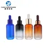 En stock nuevo botella de aceite esencial de fondo grueso 30 ml botella de esencia de hombro redondo botella con gotero de cabeza de goma cabeza de bomba botella de aceite esencial de vidrio