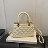 Nuevo modelo de otoño temprano 2026, bolso de mano sencillo con patrón de diamantes para mujer, bolso cruzado de moda con textura, bolso de hombro, bolsos de mujer al por mayor