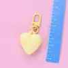 Llavero de corazón de melocotón nuevo color caramelo amor funda protectora aipods funda para auriculares colgante adornos para bolso