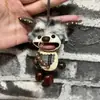 Encantador perrito peludo con la lengua fuera, llavero para bolso, colgante de dibujos animados natural, semillas de terapia de sonido curativas, popular en zonas escénicas, amuleto divertido y adorable