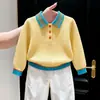 Ropa infantil coreana 2026 colección otoño/invierno nueva: suéter de punto amarillo con cuello alto texturizado y pantalones blancos casuales de pierna recta