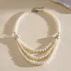 Collar geométrico de perlas de vidrio multicapa vintage europeo y americano, cadena para la clavícula minimalista de nicho, joyería de alta gama para mujer