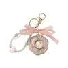 Chaveiro de Camélia com Borda de Diamante Estilo Francês de Luxo Leve com Cordão de Cristal e Pingente de Laço para Bolsa, Ornamento Exquisito para Mulheres