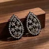 Pendientes de belleza negra con forma de gota hueca, exquisitos pendientes con incrustaciones de diamantes, estilo estrella Ruili, copos de nieve, súper brillantes y llenos de diamantes.