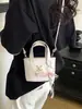Bolso de mano para mujer con estampado de rombos 2026 nuevo de moda verano moda nicho para ir al trabajo al hombro bandolera cubo