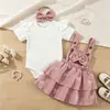 26 Set de ropa para bebé y niños europeo y americano: body acanalado + falda pastel con tirantes de pana + diadema