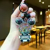 Llavero acrílico con forma de botella de arenas movedizas en aceite, regalo al por mayor, colgante de muñeca de donut, lindo llavero de arenas movedizas.