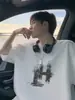 Camiseta de Manga Curta com Estampa American Graffiti para Homens Verão 2026 Nova Streetwear Solta Casual Algodão Puro Meia-Manga