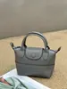 Bolso de Mano de Piel de Vaca Texturizada de Primera Capa Más Vendido Transfronterizo, Bolso Tipo Empanada de Diseño Nicho Estilo Coreano, Bolso Cruzado de Moda para Mujer