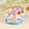 Pulsera de moda coreana nueva multicapa de línea elástica, pulsera de cerámica suave con carita sonriente encantadora, traje de pulsera de perlas retro hecha a mano para mujer