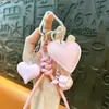 Nuevo cordón para teléfono de cuero PU con forma de corazón y colgante de bola tejida, accesorio para bolso, llavero, portallaves con anillo para coche