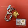 Llavero de tela con logo de empresa personalizado Cadena para teléfono móvil Angela Lámina de oro puro Oro 999 Regalo de aniversario