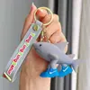 Llavero Popular Transfronterizo Shanhaijing, Versión Americana, Figura de Palo con Zapatos, Tiburón, Colgante para Bolsa de Vida Marina, Regalo Pequeño
