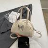 Bolso de diseño de nicho para mujer, novedad de verano 2024, estilo coreano, estilo bolos, bandolera de hombro con diseño de macarrón a juego.