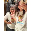 Camiseta de Algodão Pesado Respirável Estilo Fresco Manga Curta Feminina Camiseta Estampada Manga Meia Manga Top Roupas Unissex Artístico Fresco