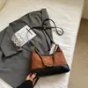 Bolso femenino súper popular de bloques de color de nicho, nuevo bolso cruzado versátil otoño e invierno 2026, bolso tipo empanada súper popular de un solo hombro para llevar debajo del brazo