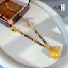 Retención de Color Alta Nuevo Estilo Chino Bolsa de Terciopelo Incrustada con Diamantes Collar de Piedra Ojo de Tigre Calabaza Cadena de Suéter Fulu Estilo Chino CNC para Mujer