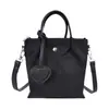 Bolso tote de nailon de nicho estilo coreano para mujer, nuevo y moderno de alta gama tipo cubo 2026, bolso cruzado versátil