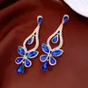 Pendientes de borla con flor de trébol de circonita vintage con un toque de alta gama, pendientes versátiles y de moda al por mayor
