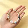 Venta Caliente al por Mayor Nueve Morados Li Fuego Aprendizaje en Orilla Lámina de Oro Porcelana Esmaltada Amatista Wenchang Pluma Pulsera de Cuenta Única Regalo para Compañeros