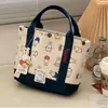 Bolsa de Mão Estilo Japonês Ins Fofa Bordada em Lona para Mulheres, Novo Modelo para Mães, Bolsa Tote Portátil para Sair, Lancheira para o Trabalho