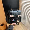 Mochila transfronteiriça estilo coreano com laço para mulheres, novo modelo 2026, simples e elegante, bolsa quadrada pequena de alta aparência, mochila multifuncional