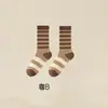 Calcetines de otoño e invierno Zhuji calcetines de tubo para mujer otoño e invierno marrón Maillard calcetines de felpa vintage medias sin costuras de invierno