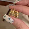 Nuevos pendientes de estrella hueca inspirados en Chanel para mujer, diseño de alta gama, tachuelas de trébol de cuatro hojas de lujo ligero, pendientes simples y únicos