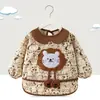 Babero de terciopelo de cristal para bebé, impermeable, antidesgaste, con bolsillo de arroz, para otoño e invierno, delantal para madre y bebé.