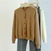 Foto real de suéter cardigã de tricô oversized com fio core de outono e inverno para mulheres, adequado para usar tanto por dentro quanto por fora, com botões bordados em formato de coração