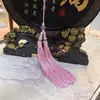 Al por mayor de fábrica borla antigua instrumento musical flauta accesorios hechos a mano diy borla de púas de doble bigote de loto para colgar en el coche de alta calidad