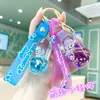Chaveiro Estrela Preenchido com Óleo e Areia Movediça Desenho Animado, Chaveiro de Boneca Transparente em Acrílico com Areia Movediça, Decoração para Mochila de Estudante