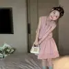 Conjunto de Niña 2026 Verano Nuevo Top sin Mangas Tipo Muñeca para Bebé Falda Corta Elegante Moda Infantil Conjunto de Dos Piezas