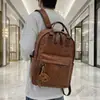 Mochila Escolar de Couro PU Retrô 2026 Nova Tendência Cool Mochila de Grande Capacidade Versátil Bolsa para Roupas de Trabalho Viagem Computador