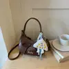 Bolsa Transfronteiriça de Nicho com Laço para Mulheres Outono 2026 Nova Bolsa Meia-Lua Texturizada para o Dia a Dia Bolsa Bolinho Bolsa Transversal Tendência