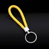 Llavero colgante de cuerda de cuero tejido de fábrica con cabeza de plástico para pareja, llavero de coche de cuero, colgante, accesorios, venta al por mayor