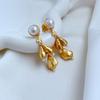 Moda europea y americana lujo ligero viajero diseño nicho ins concha con incrustaciones de perlas aretes metálicos mate de múltiples colgantes