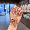 Llavero de arco de arcilla con diamantes completos, colgante de cadena de cuentas de cristal de moda, accesorio de bolso para chica dulce y genial, cadena para colgar el teléfono