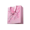 Bolsa de papel tipo tote sin cintura con patrón de lazo de pedrería en forma de corazón, estilo juvenil, adecuada para compras de cosméticos y empaque de regalos