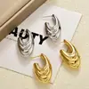 Pendientes de Gancho Curvo Plegados Huecos Estilo Ins Europeo y Americano Transfronterizos, Chapados en Cobre con Oro Real, Pendientes de Moda con un Toque de Lujo Ligero y de Alta Gama