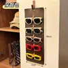 Nuevo modelo de bolsa colgante para guardar gafas para uso doméstico, protector de gafas de sol de gran capacidad montado en la pared, estante expositor de gafas de sol de cuero vintage