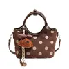 Exquisito bolso de mano de lunares de nicho estilo coreano para mujer, principios de otoño de 2026, bolso de hombro y cruzado Maillard de alta gama y elegante